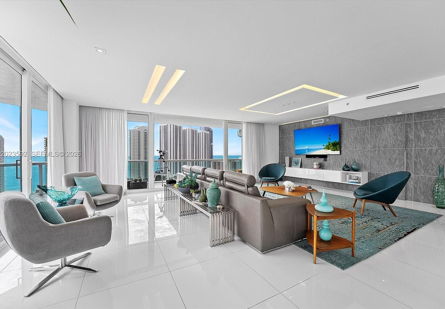 Second view of the great room showing the wrap-around sightline from interior to the Sunny Isles skyline